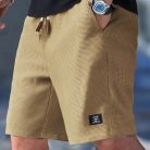 Men wearing lightweight casual sports shorts with drawstring waistband and side pockets for summer activewear