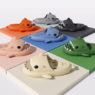 Unisex quick drying shark slippers with drain holes made of comfortable EVA foam.