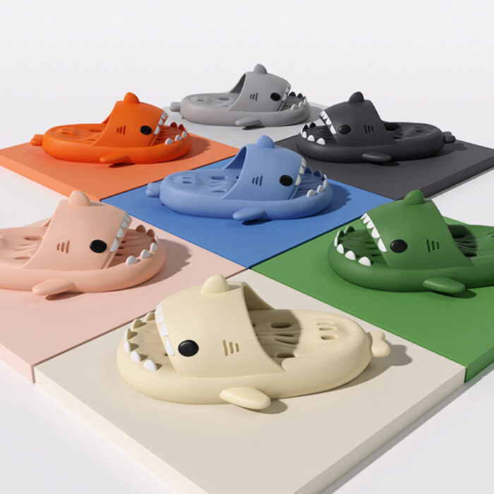 15ab0e2b-1448-4f3f-8bce-bc1b67d27c8d.jpg Unisex quick drying shark slippers with drain holes made of comfortable EVA foam.