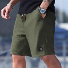 Men wearing lightweight casual sports shorts with drawstring waistband and side pockets for summer activewear