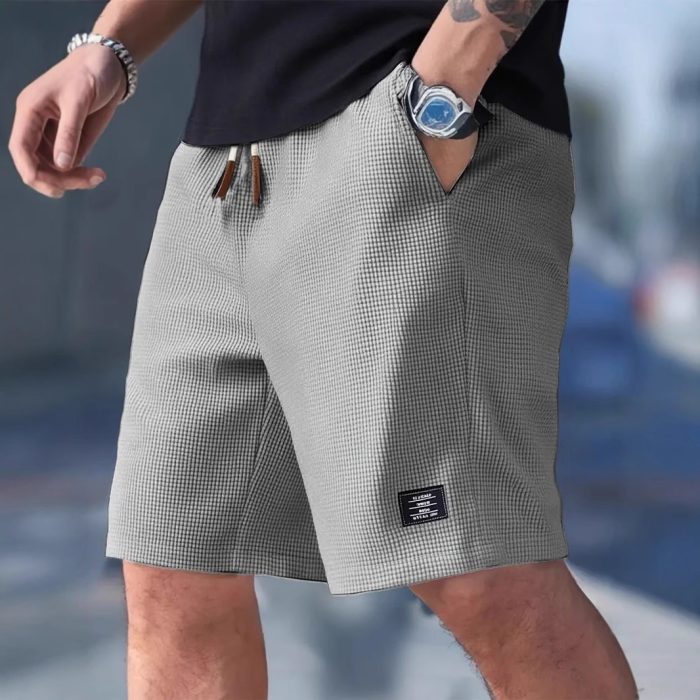 3b5ee9b7-1f0e-4f3a-831c-03aae6164692-3.jpg Men wearing lightweight casual sports shorts with drawstring waistband and side pockets for summer activewear