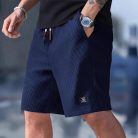 Men wearing lightweight casual sports shorts with drawstring waistband and side pockets for summer activewear