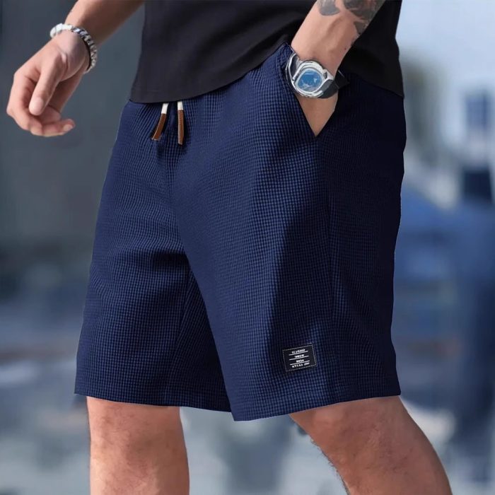 662640ac-e079-44e0-b957-382d17829d36-2.jpg Men wearing lightweight casual sports shorts with drawstring waistband and side pockets for summer activewear