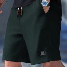 Men wearing lightweight casual sports shorts with drawstring waistband and side pockets for summer activewear