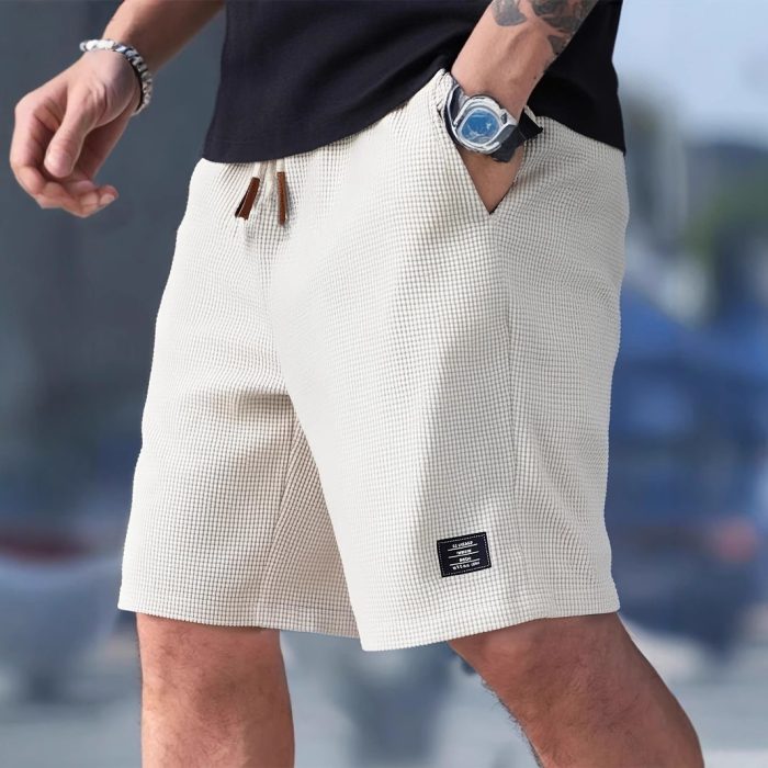 c29e8833-3f6c-4f3c-aa13-c2d3d73c3822-2.jpg Men wearing lightweight casual sports shorts with drawstring waistband and side pockets for summer activewear
