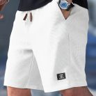 Men wearing lightweight casual sports shorts with drawstring waistband and side pockets for summer activewear
