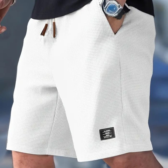 f9612901-32ff-4a40-bd8f-5baaac28ff93-2.jpg Men wearing lightweight casual sports shorts with drawstring waistband and side pockets for summer activewear