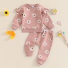 Cute toddler wearing a cozy baby girl floral outfit with a daisy print long-sleeve top and matching pants.