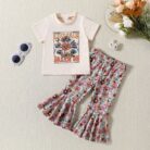 Cute toddler girl smiling and wearing a trendy toddler girl bell bottom outfit with a floral print.