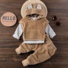Handsome toddler boy smiling in a stylish boys 3 piece hoodie terno set.