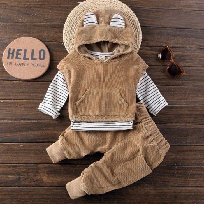 Handsome toddler boy smiling in a stylish boys 3 piece hoodie terno set.