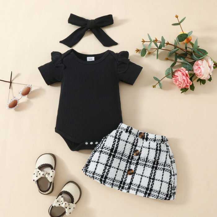 Happy baby girl wearing a stylish baby girl plaid skirt set with a matching headband.