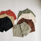 Young child playing outdoors wearing vibrant kids candy color shorts.
