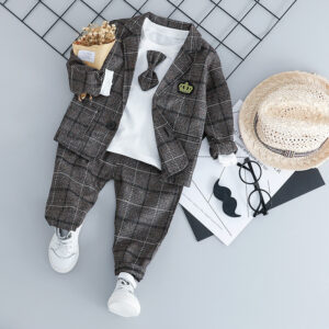 Handsome toddler boy dressed in a stylish boys 3 piece formal terno.