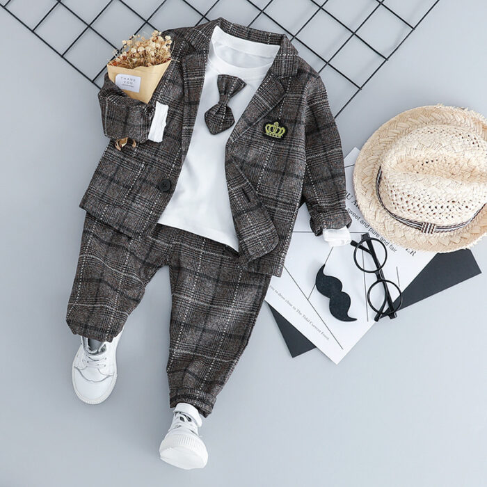 Handsome toddler boy dressed in a stylish boys 3 piece formal terno.