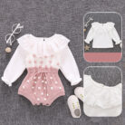 Cute baby girl wearing a cozy, minimalist baby girl long sleeve romper.