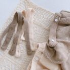 Adorable baby girl wearing a trendy boho baby girl suspender romper.