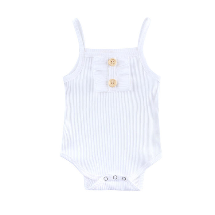 Baby girl smiling in a beautifully soft baby girl romper and skirt set.