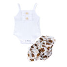 Baby girl smiling in a beautifully soft baby girl romper and skirt set.
