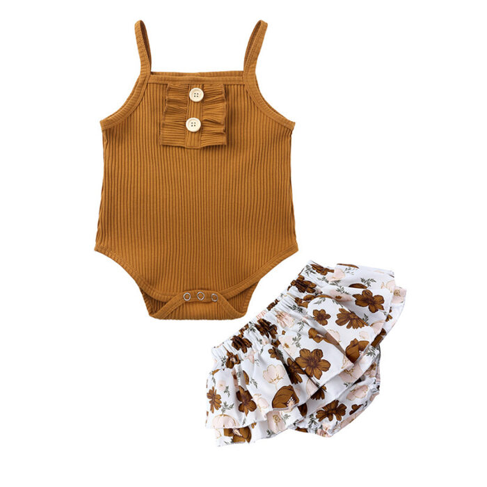 Baby girl smiling in a beautifully soft baby girl romper and skirt set.