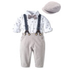 Handsome little boy wearing a stylish boys formal suspender terno set.