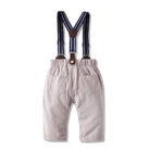 Handsome little boy wearing a stylish boys formal suspender terno set.