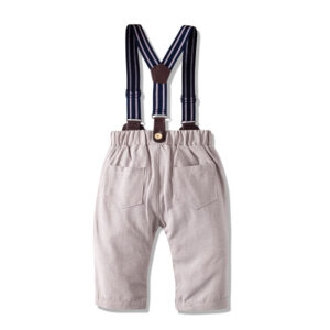 Handsome little boy wearing a stylish boys formal suspender terno set.