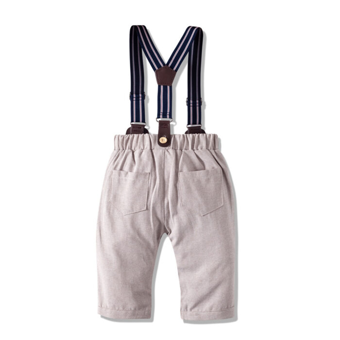 Handsome little boy wearing a stylish boys formal suspender terno set.