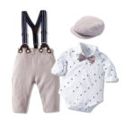 Handsome little boy wearing a stylish boys formal suspender terno set.