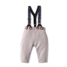 Handsome little boy wearing a stylish boys formal suspender terno set.