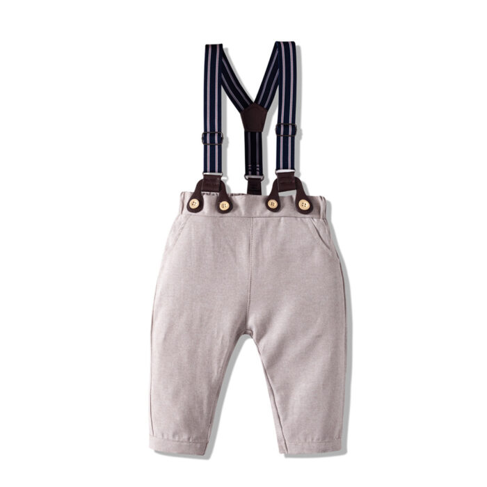 Handsome little boy wearing a stylish boys formal suspender terno set.