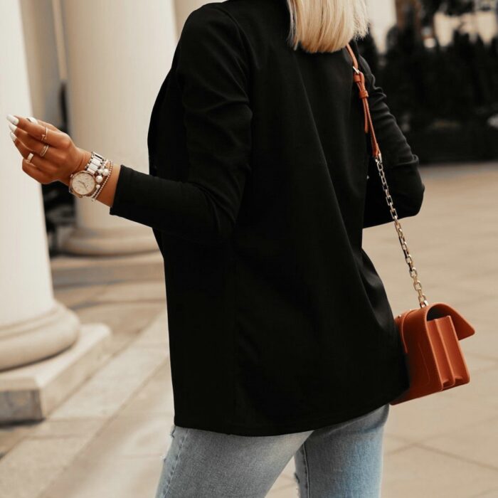 Stylish woman wearing a tailored black women's casual slim fit blazer.
