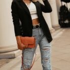 Stylish woman wearing a tailored black women's casual slim fit blazer.