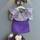 Happy little girl smiling in a beautifully stylish girls ruffle collar skirt set.