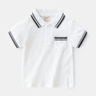 Young boy smiling outdoors wearing a comfortable boys short sleeve summer polo.