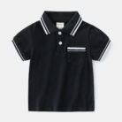 Young boy smiling outdoors wearing a comfortable boys short sleeve summer polo.