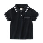 Young boy smiling outdoors wearing a comfortable boys short sleeve summer polo.