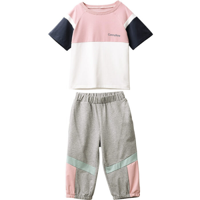 1623475056436.jpg Older child smiling outdoors wearing a trendy pink kids sporty two piece set.