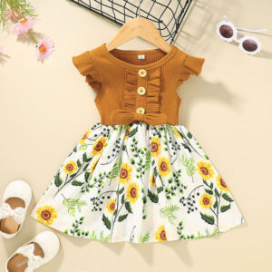 Cute toddler girl wearing a comfortable and colorful toddler girls summer dress outdoors.