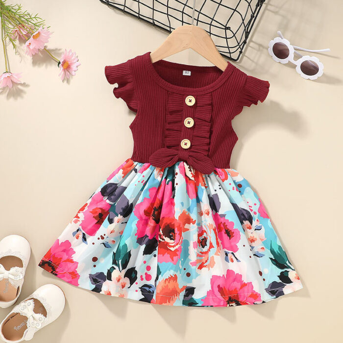 Cute toddler girl wearing a comfortable and colorful toddler girls summer dress outdoors.
