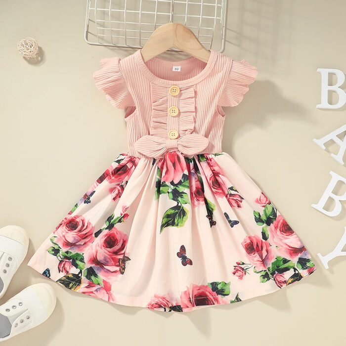 Cute toddler girl wearing a comfortable and colorful toddler girls summer dress outdoors.