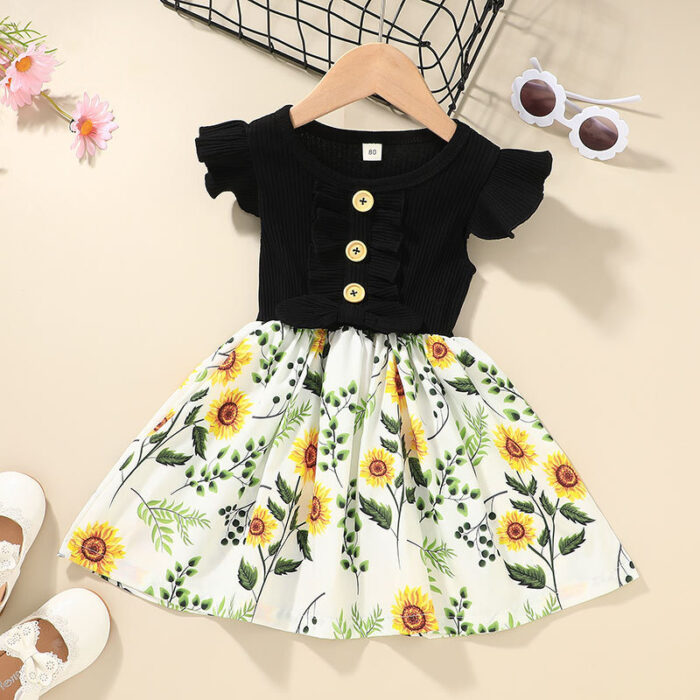 Cute toddler girl wearing a comfortable and colorful toddler girls summer dress outdoors.