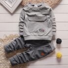 Active toddler playing happily in a comfortable toddler terno set.