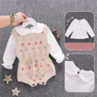 Cute baby girl wearing a cozy, minimalist baby girl long sleeve romper.