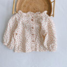 Adorable baby girl wearing a trendy boho baby girl suspender romper.