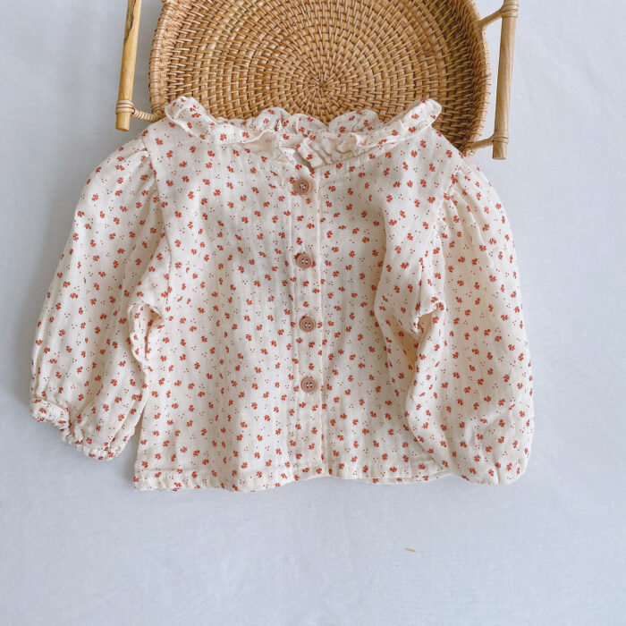 Adorable baby girl wearing a trendy boho baby girl suspender romper.