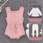Cute baby girl wearing a cozy, minimalist baby girl long sleeve romper.