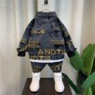 Handsome little boy wearing a stylish boys casual denim terno set.