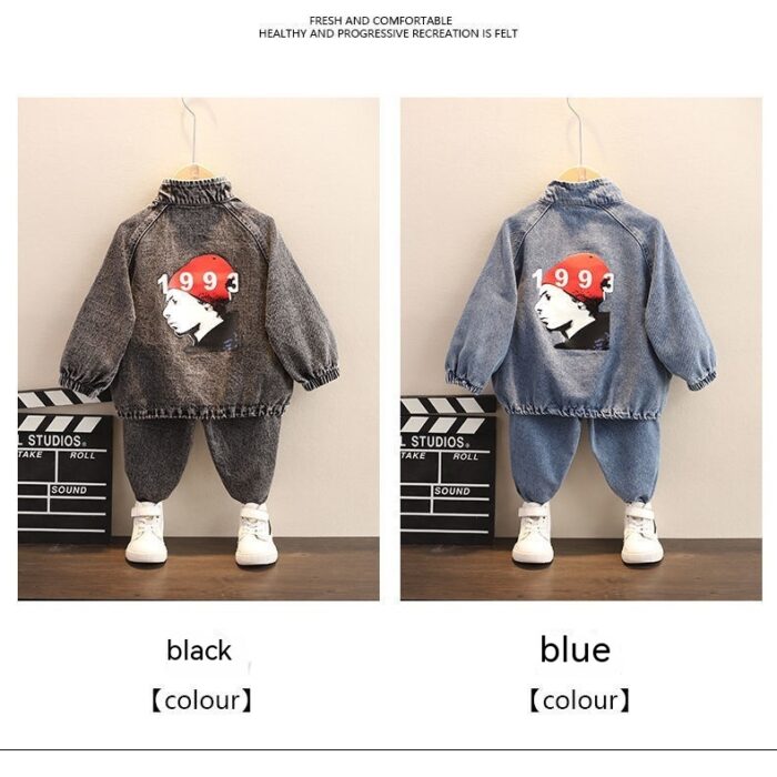Stylish little boy smiling outdoors in a cool boys denim terno set.