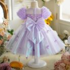 Happy little girl twirling in a beautiful girls short sleeve princess dress.